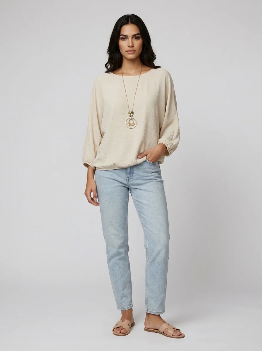 Light beige top with necklace